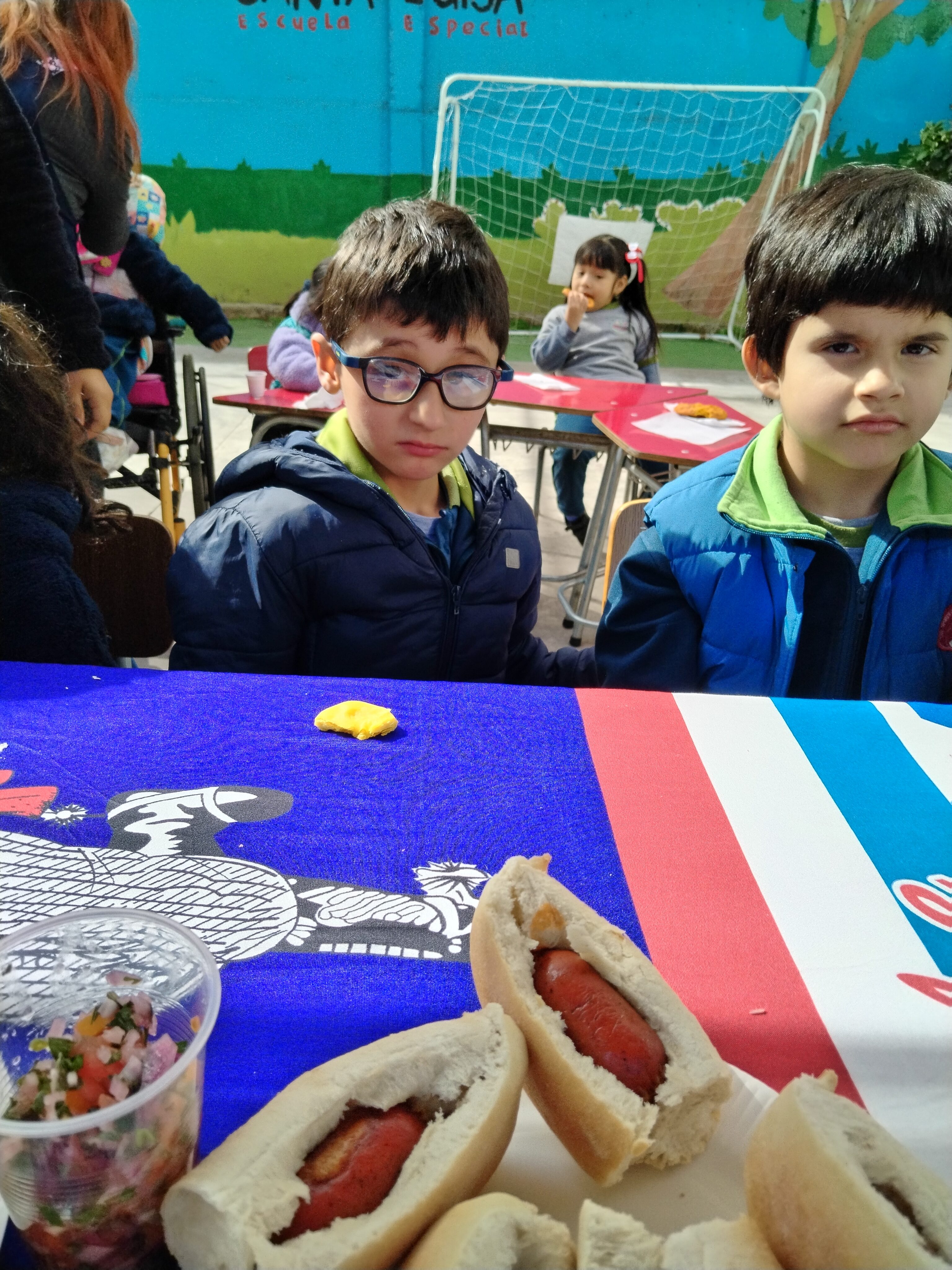 Estudiantes en actividad escolar con desayuno y mesa compartida